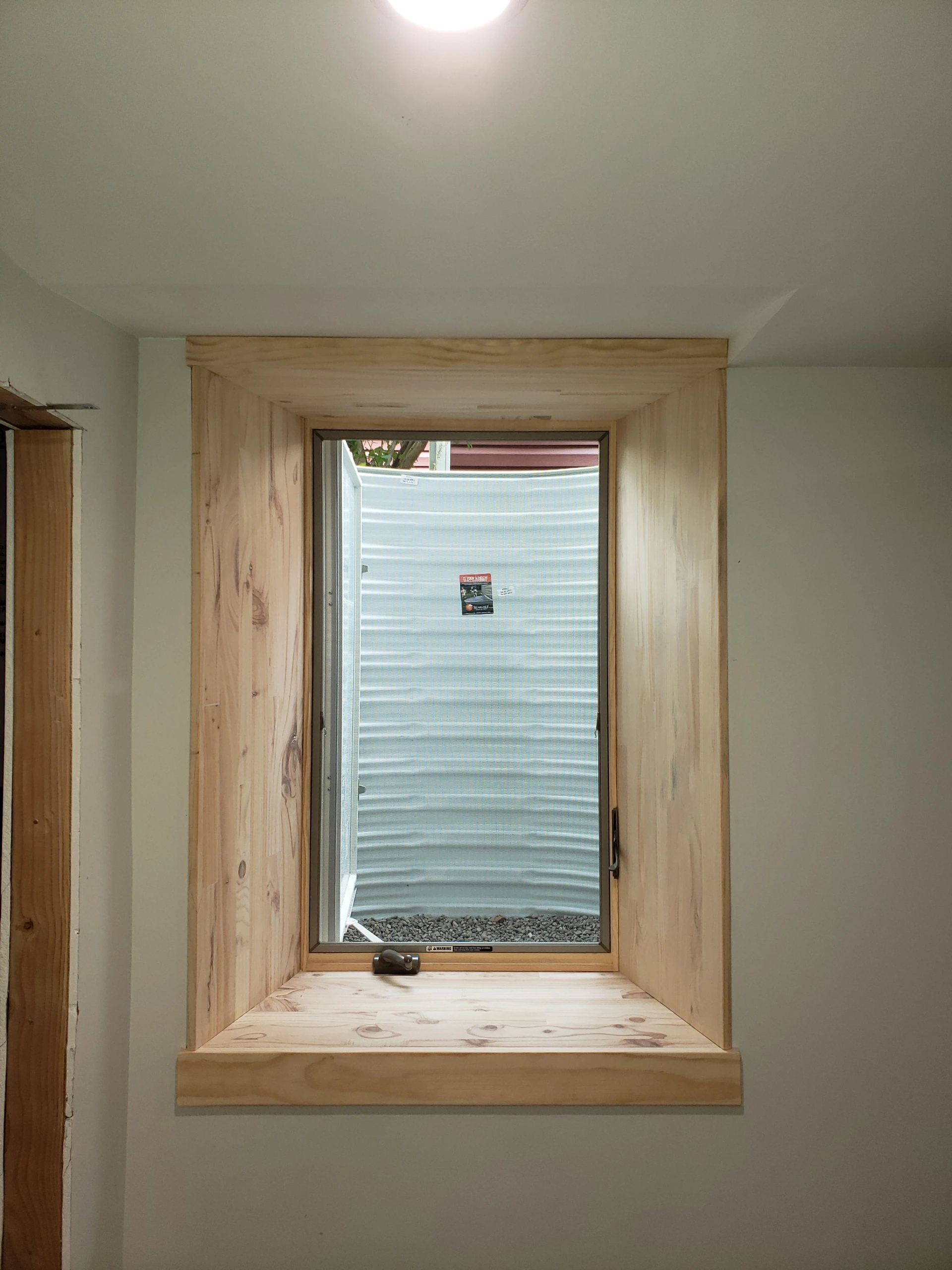 Oak interior egress window trim installed in basement Twin Cities Metro MN