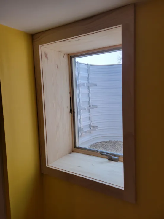 Interior egress window with pine trim open