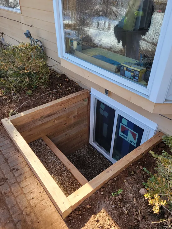 Large double timber egress well yard view